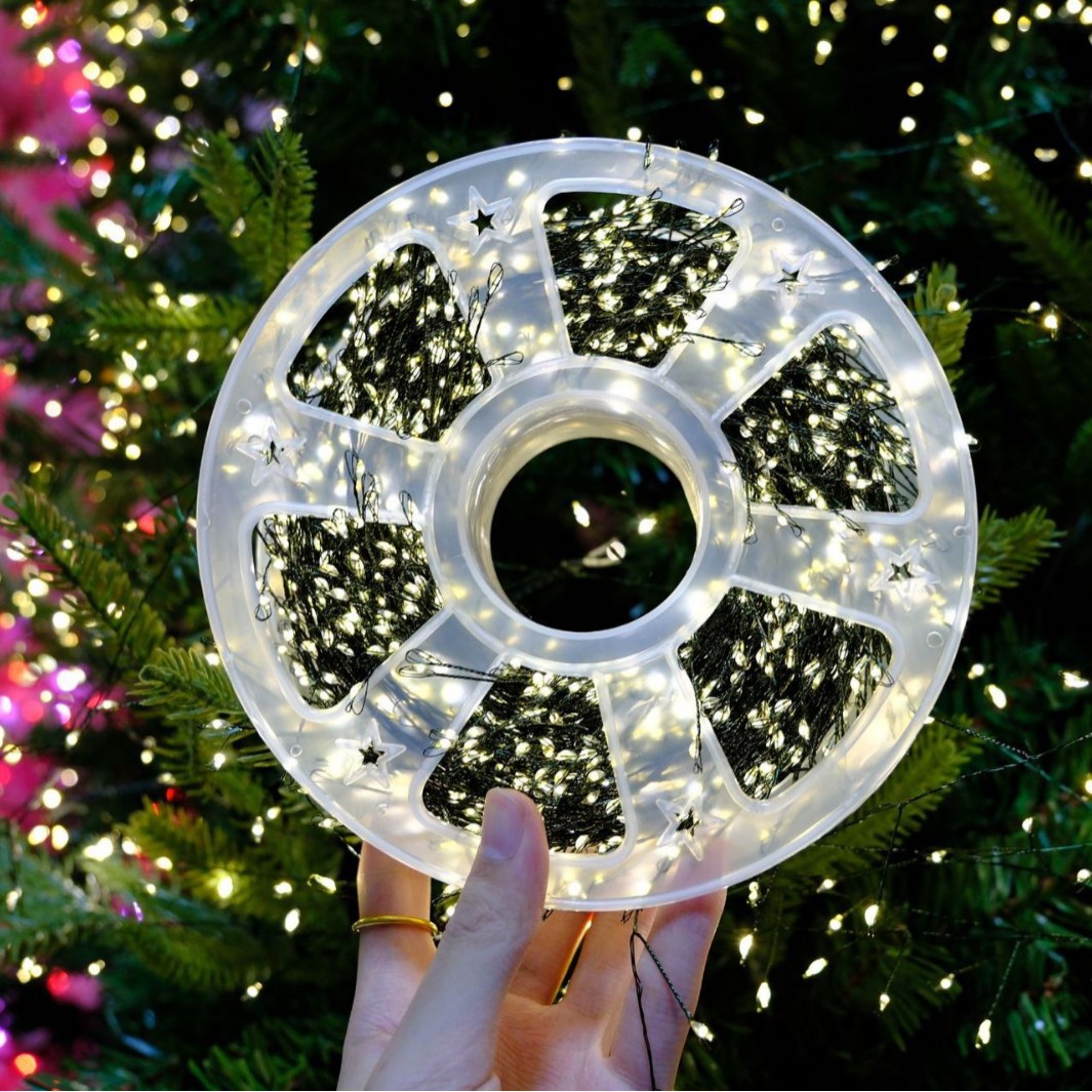 328-foot warm white LED Christmas light string with 1,000 bulbs, featuring invisible green wiring and multiple remote control modes. IP65 waterproof and cold-resistant, designed specifically for Christmas trees, gardens, and weddings.
